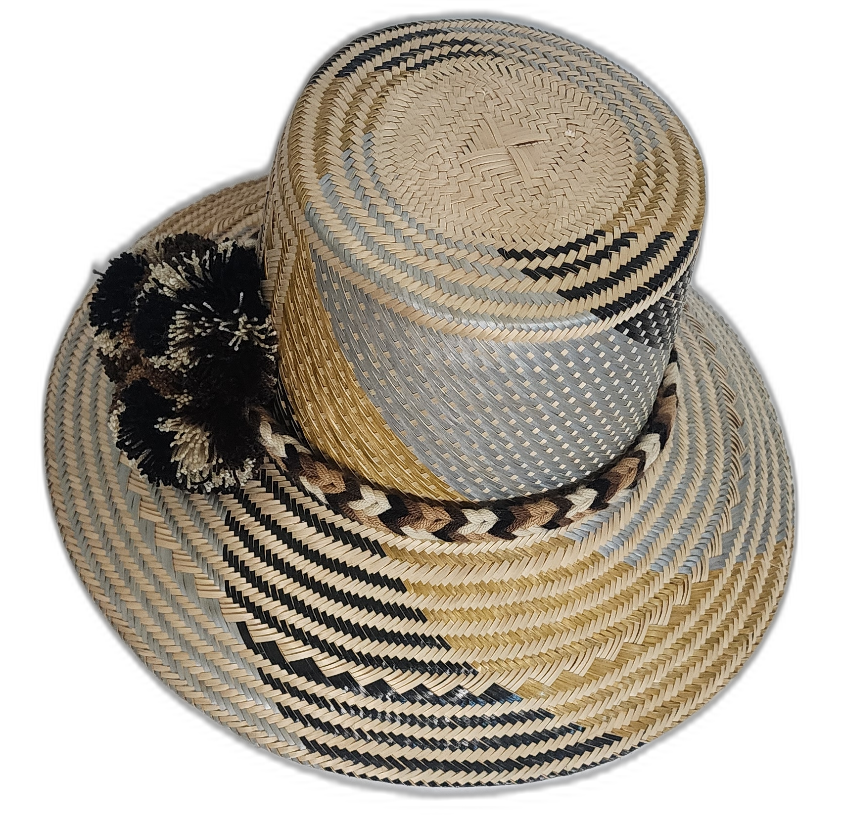 Artisan Wayuu hat featuring neutral palette, braided band, and bold pompoms.