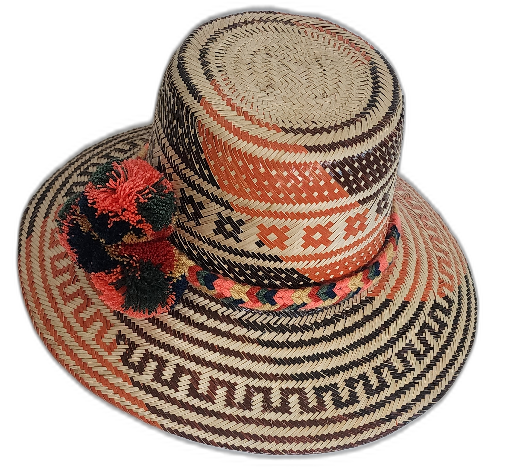Artisan boho straw hat in natural straw with red and black patterns and colorful pompoms.

Wayuu hat with bold woven design and handcrafted green and red pompoms.
