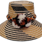 Trinity handmade Wayuu hat with black, natural, and mustard weave and earth-tone pompoms

