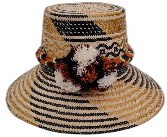 Trinity handmade Wayuu hat with black, natural, and mustard weave and earth-tone pompoms

