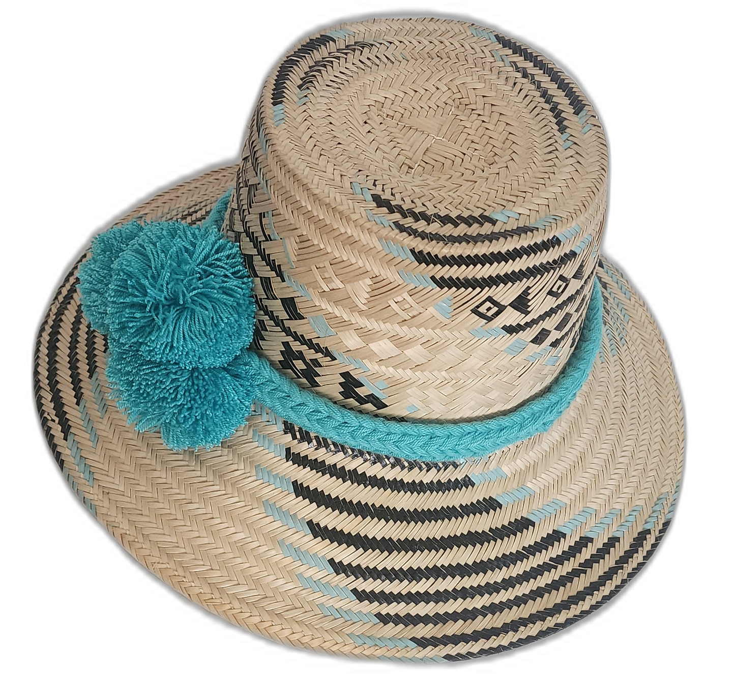 Artisan straw hat with bold symmetry and soft blue pompoms, woven from natural iraca palm fibers.

