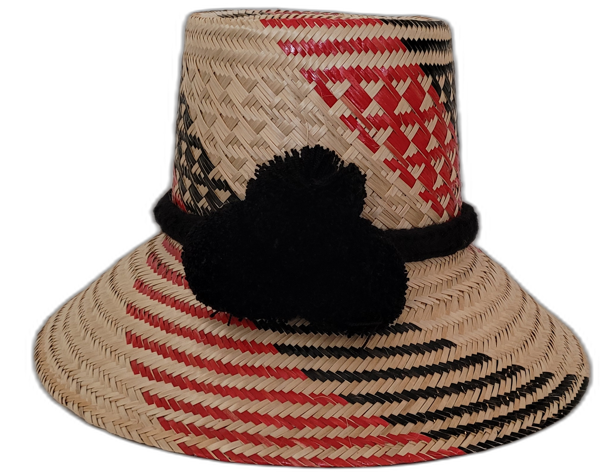 Vanessa handmade Wayuu straw hat in red and black with decorative black pompoms

