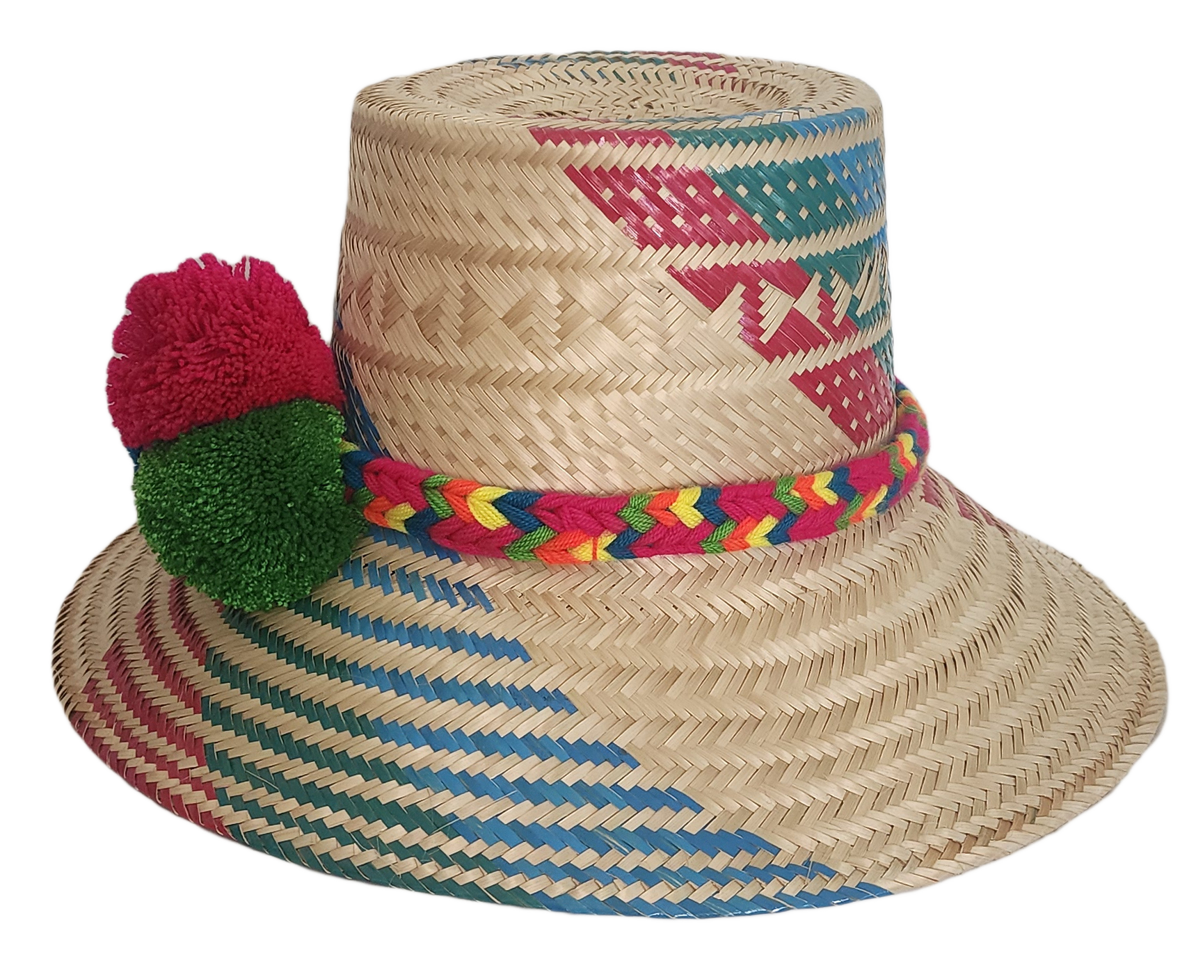 Boho chic straw hat crafted by Wayuu artisans, featuring bold woven patterns and pompom trim.


