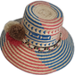Artisan-crafted Wayuu hat featuring geometric weave and statement pompoms.