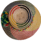Colorful Wayuu straw hat handmade with striking woven patterns and green pompoms.