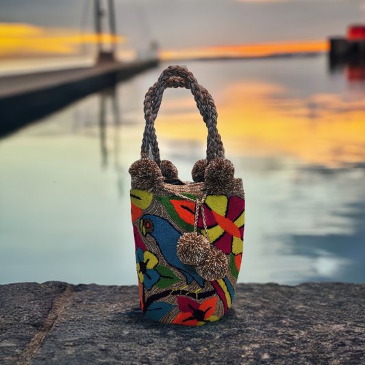 Handmade Wayuu punch-needle bag with colorful bird and floral boho design