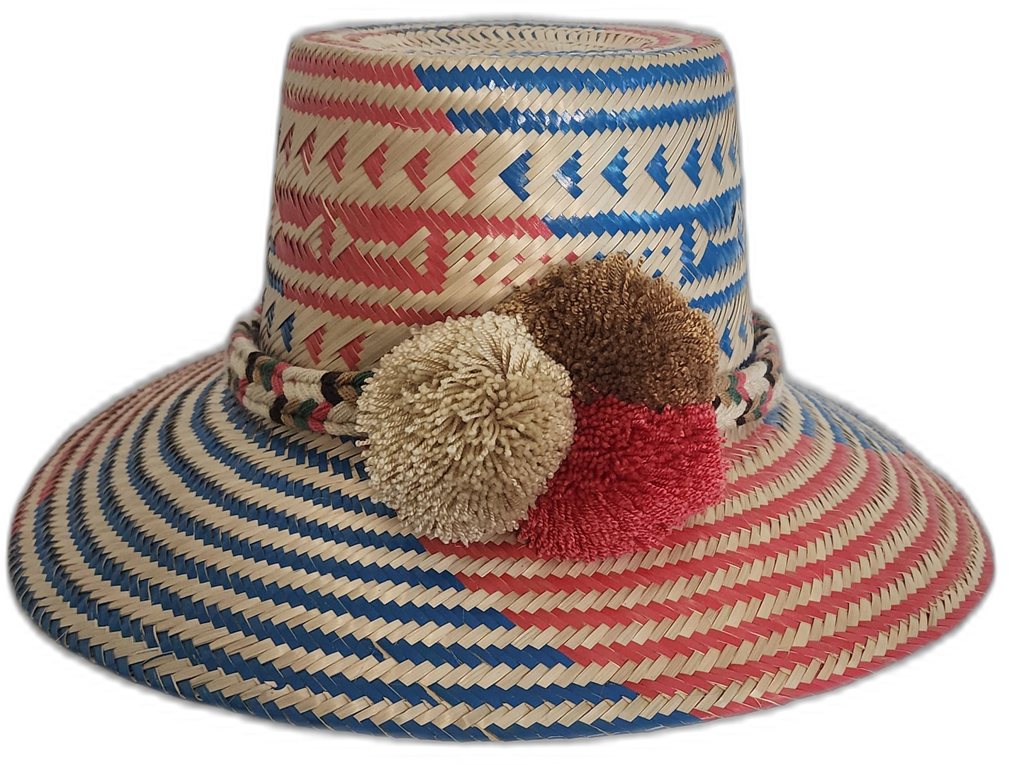 Handmade Wayuu straw hat with red and blue weave and ivory, brown, and red pompoms.