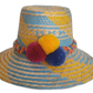 Colorful Wayuu handmade hat with blue and yellow straw weaving and vibrant red, yellow, and blue pompoms.