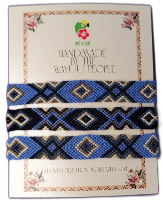 Handmade Wayuu friendship bracelets in blue, black, and cream tones.