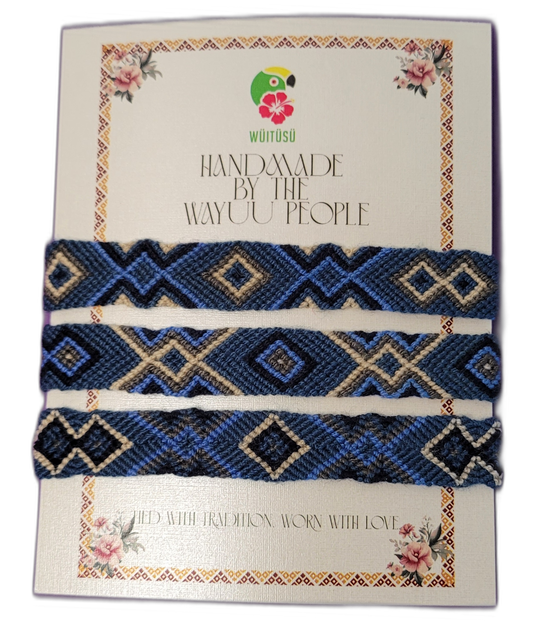 Handmade Wayuu friendship bracelets in blue, cream, and black.
