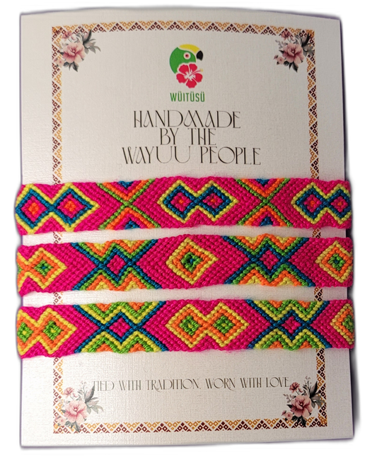 Handmade Wayuu friendship bracelets in bright pink, orange, and green.