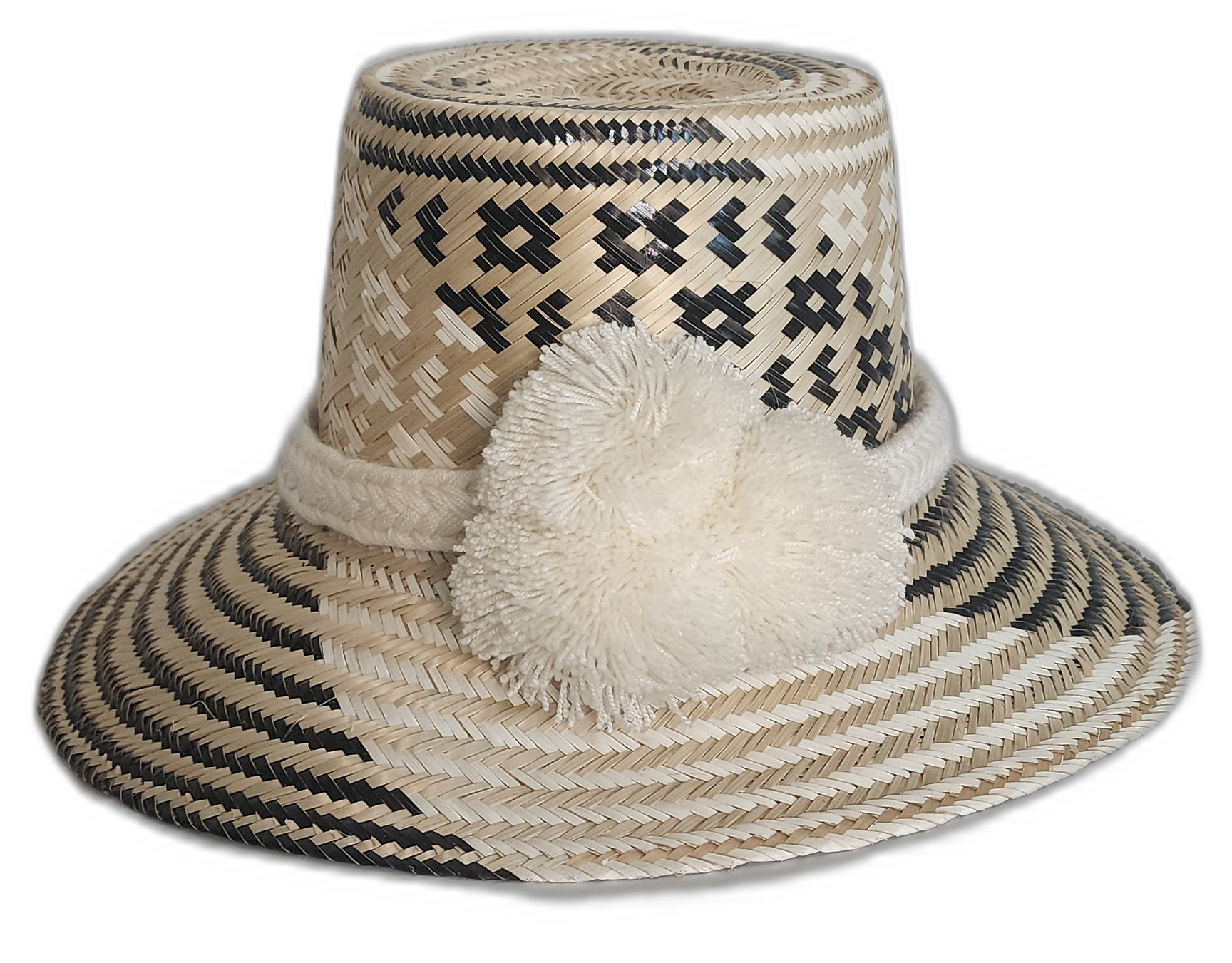 Handmade Wayuu boho straw hat with black and natural geometric weaving and ivory pompoms.