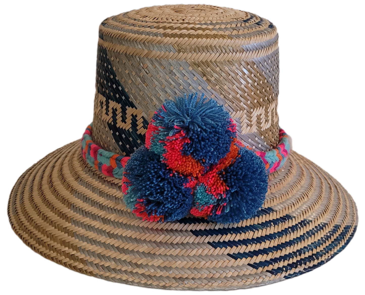 Handmade Wayuu straw hat with blue, coral, and teal pompoms.