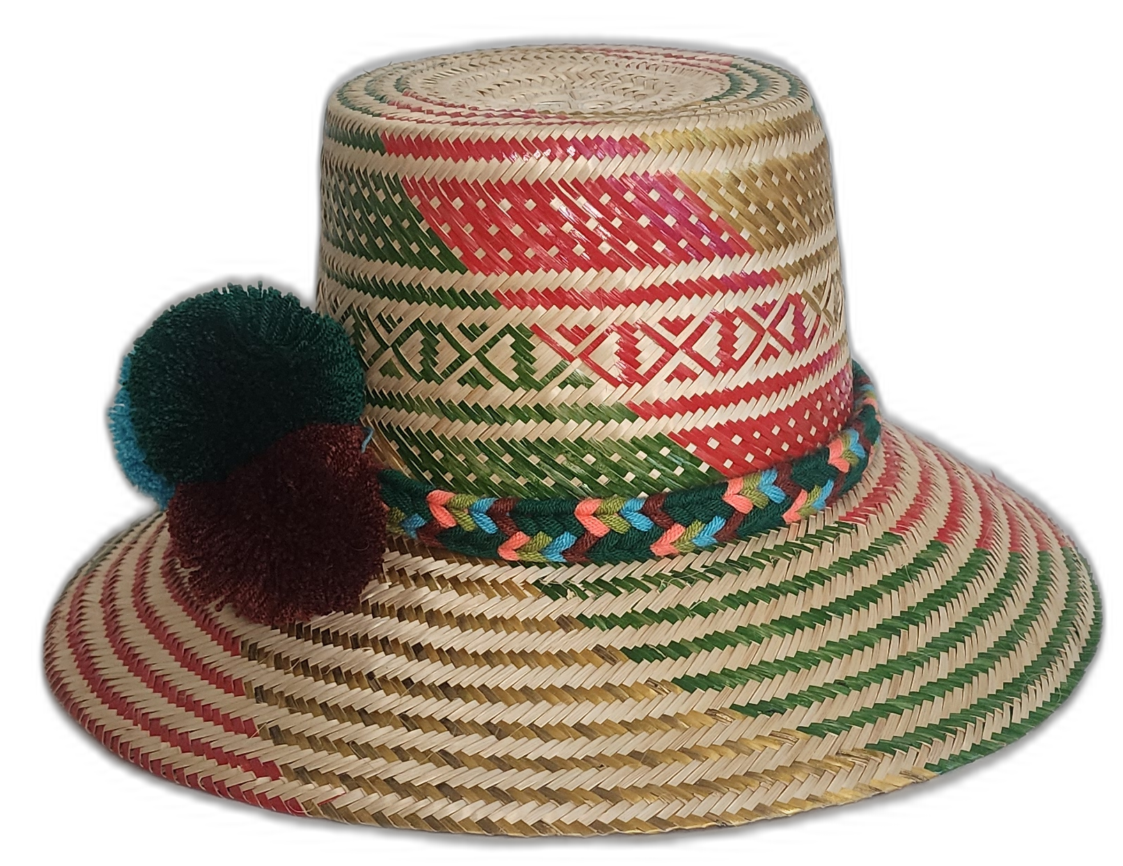 Handmade Wayuu straw hat with red and green woven patterns, colorful braided band, and deep-toned pompoms.