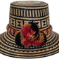 Handmade Wayuu straw hat with geometric patterns and red-black pompoms