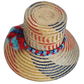 Artisan straw hat featuring bold primary weave and braided color band