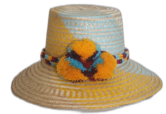 Handmade Wayuu straw hat with yellow and blue weaving, accented with bold yellow and sky blue pompoms.