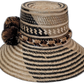 Boho straw hat Zuri with natural, black, and brown palm fiber and cultural pompoms


