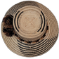 Artisan Wayuu hat Zuri crafted in earth tones with large brown and black pompoms

