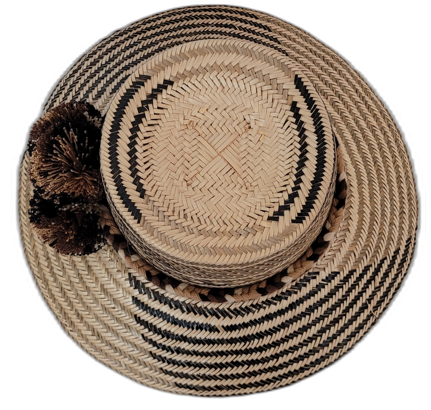 Artisan Wayuu hat Zuri crafted in earth tones with large brown and black pompoms


